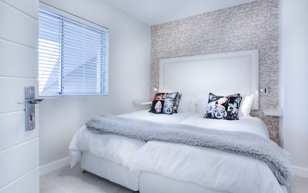 Apartments in Miramar A white bedroom with a bed and pillows. Miramar Park Apartments
