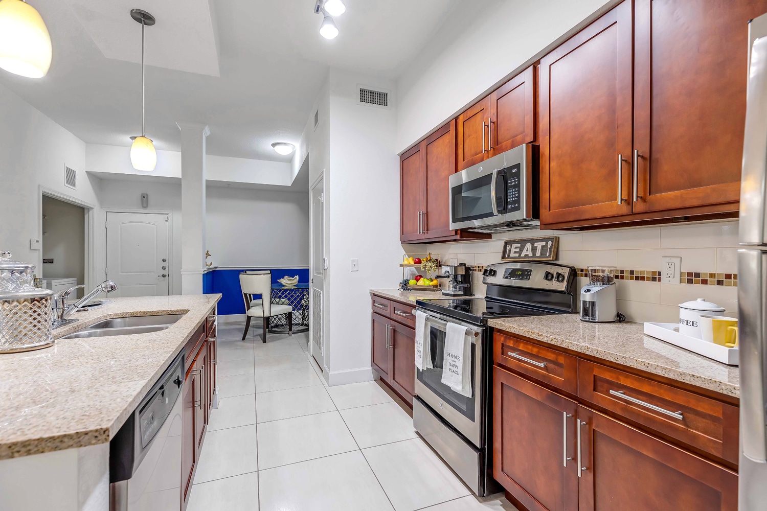 Apartments in Miramar A kitchen with stainless steel appliances and granite counter tops. Miramar Park Apartments